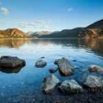 Rocks on the shores of Ennerdale Water at sunset.